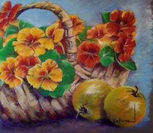 Fleurs capucines orange et jaune dans un panier avec 2 pommes devant